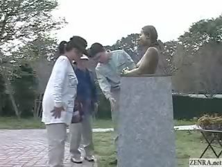 Green Japanese garden statue has tits felt up