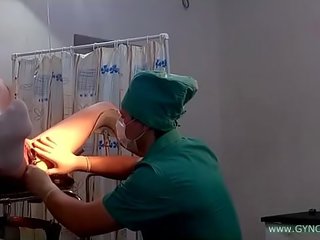 A young young teenager in white socks on a gynecological chair